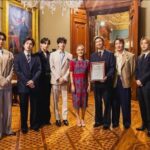 A picture of the BTS band at the Mexican presidential palace